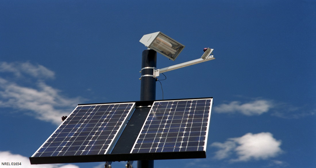 a pair of solar panels wired to a flood light